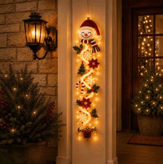 Velmerry Glowing Christmas Door Hanger glowing beside a front door