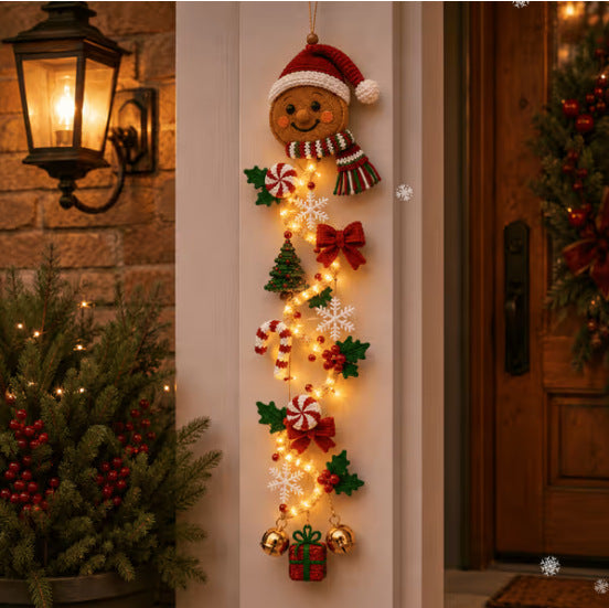 Velmerry Glowing Christmas Door Hanger, Gingerbread character, illuminated at a front door